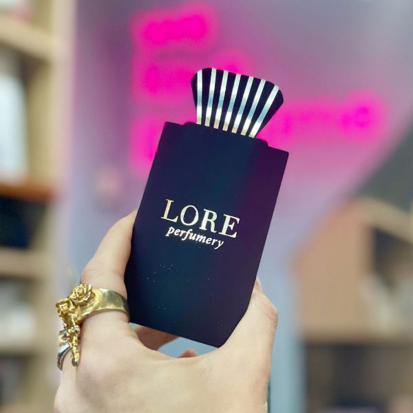 photo of a hand holding a lore perfumery in-store gift voucher