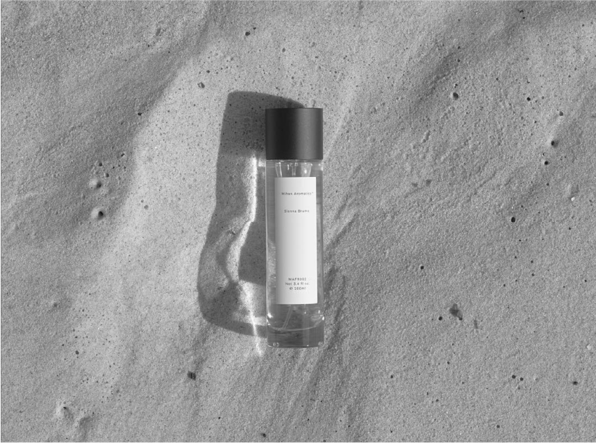 black and white photo of sienna brume by mihan aromatics on sand