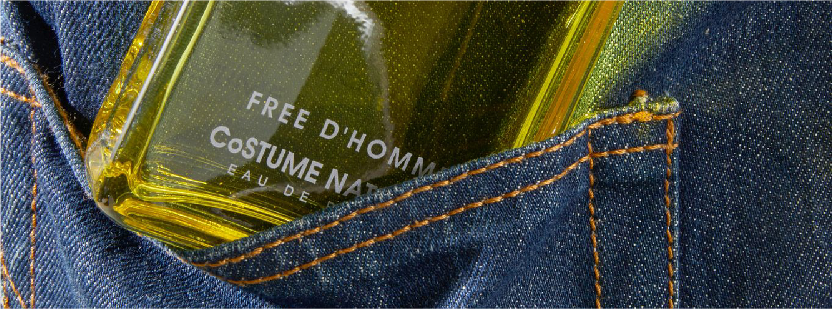 bottle of free d'homme by costume national in a denim pocket