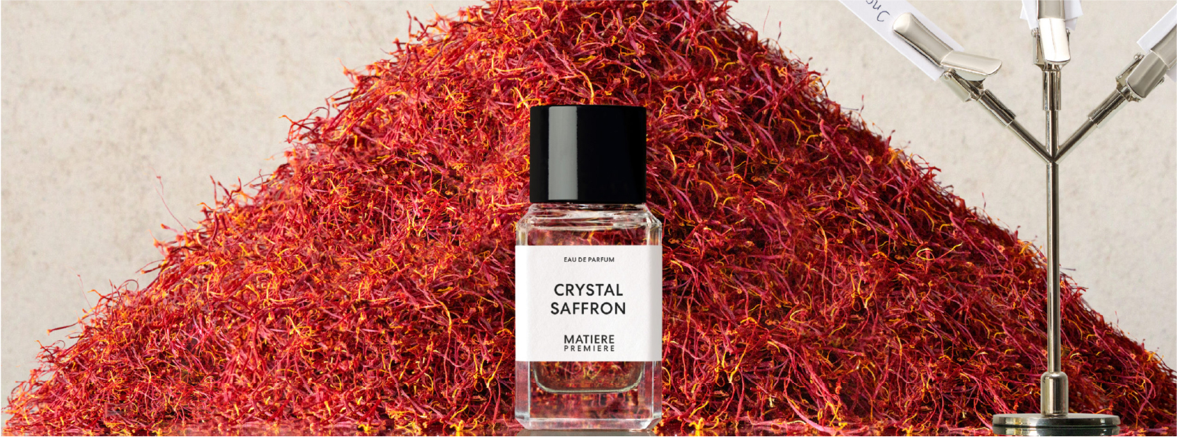 bottle of crystal saffron by matiere premiere in front of a pile of saffron