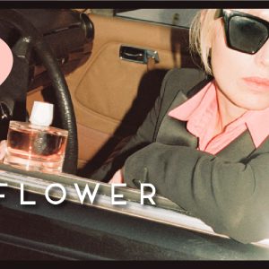 photo of woman in a car with a bottle of sonic flower by room 1015