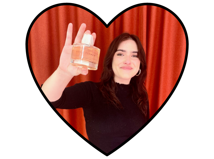 photo of laura from lore perfumery holding sonic flower fragrance by room 1015