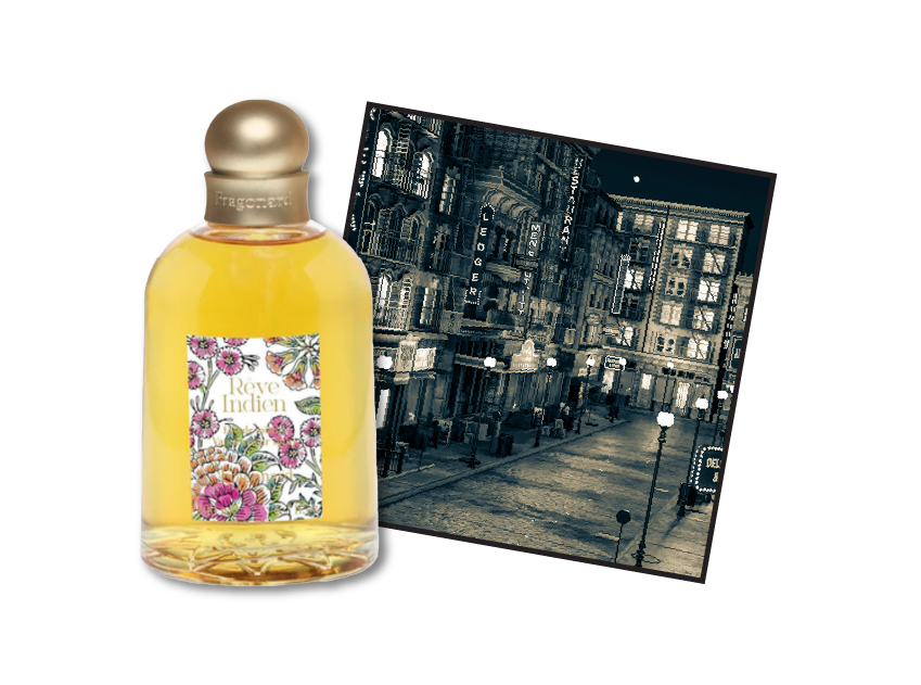 bottle of reve indien by fragonard with a photo of a city in the 1920s