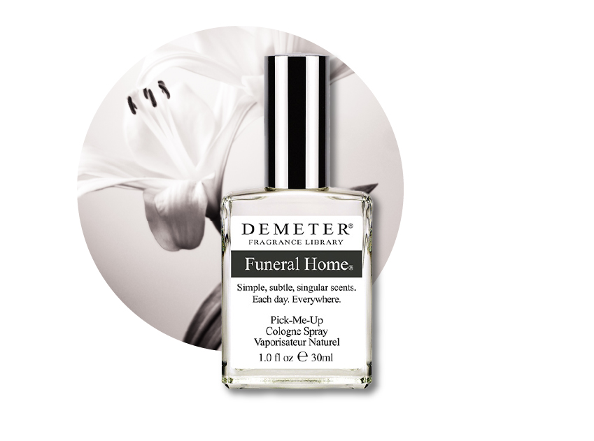 a bottle of funeral home perfume by demeter with a photo of white lillies