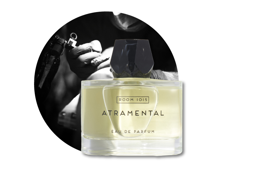a bottle of atramental perfume by room 1015 with a photo of a tattooist tattooing