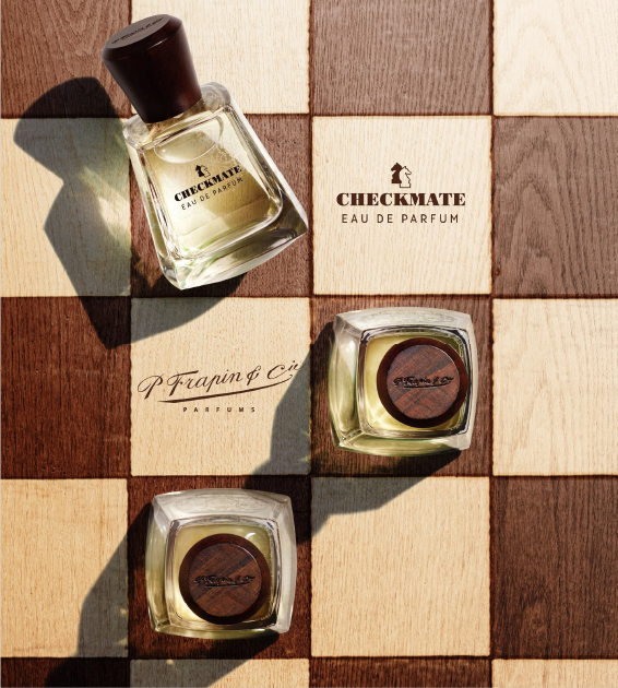 bottles of checkmate by p frapin and cie on a chessboard